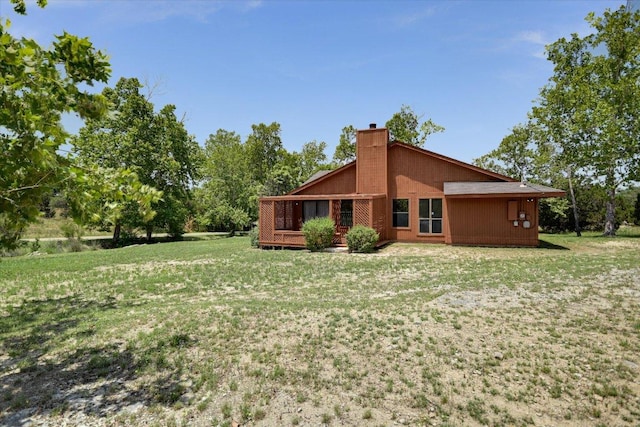 405 S Cowal Dr, Spicewood, TX 78669 - rear view of house featuring a chimney and a yard