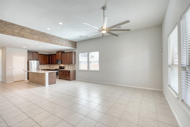 183 Concho Creek Loop, Leander, TX 78641 - kitchen featuring stainless steel appliances, open floor plan, decorative backsplash, recessed lighting, and a ceiling fan