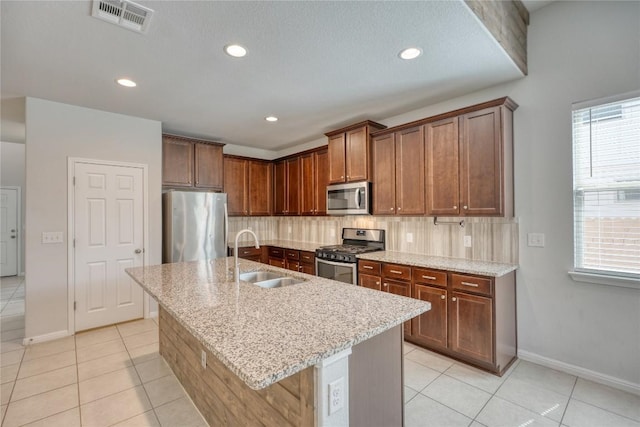 183 Concho Creek Loop, Leander, TX 78641 - kitchen featuring stainless steel appliances, backsplash, light tile patterned flooring, plenty of natural light, and recessed lighting