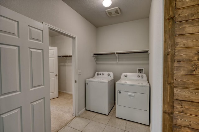183 Concho Creek Loop, Leander, TX 78641 - laundry room featuring independent washer and dryer, light tile patterned floors, and light carpet