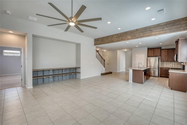 183 Concho Creek Loop, Leander, TX 78641 - kitchen with freestanding refrigerator, open floor plan, a kitchen island with sink, ceiling fan, and recessed lighting