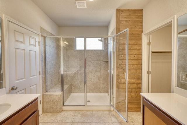 183 Concho Creek Loop, Leander, TX 78641 - bathroom with vanity, a shower stall, tile patterned floors, and a spacious closet