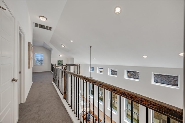 hallway with vaulted ceiling, carpet flooring, recessed lighting, and visible vents