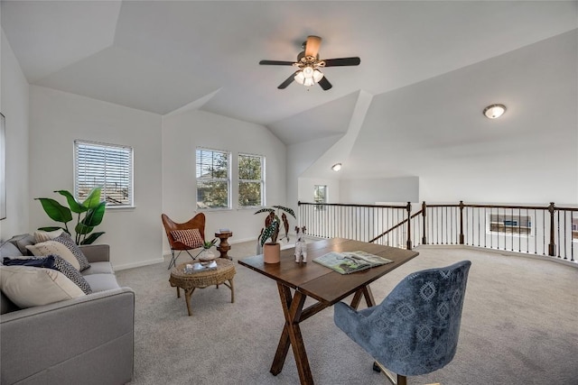 interior space with lofted ceiling, carpet flooring, baseboards, and ceiling fan