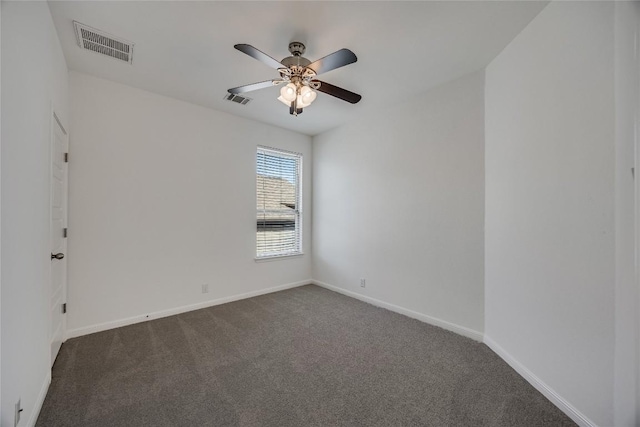 spare room with a ceiling fan, baseboards, visible vents, and dark carpet