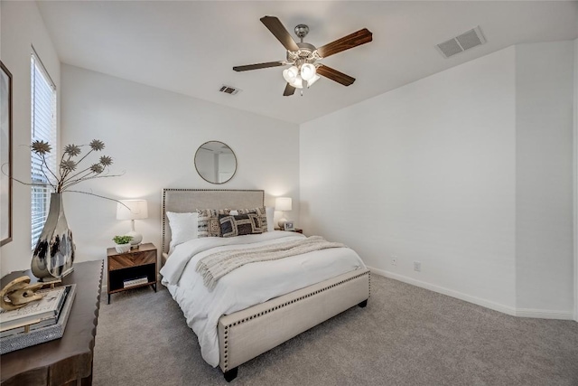 bedroom featuring visible vents, carpet floors, baseboards, and a ceiling fan