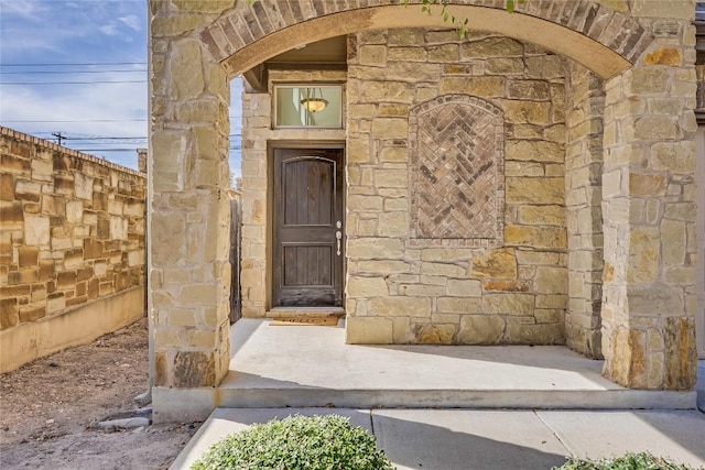 doorway to property featuring stone siding