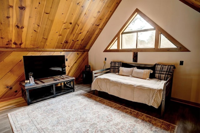 bedroom with lofted ceiling, wood finished floors, wooden walls, baseboards, and wood ceiling