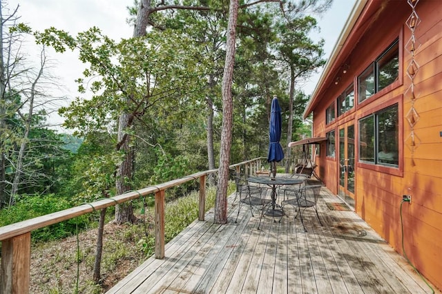 deck with outdoor dining area and french doors