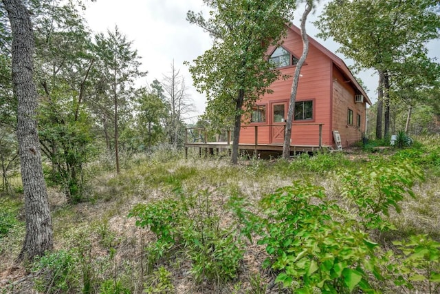 back of house with a deck