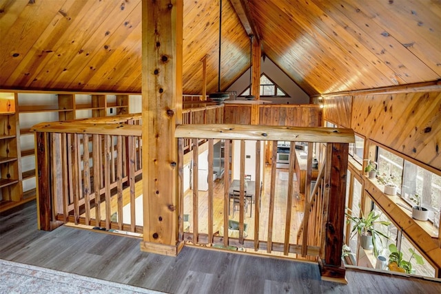 interior space with beamed ceiling, wood ceiling, and wood finished floors