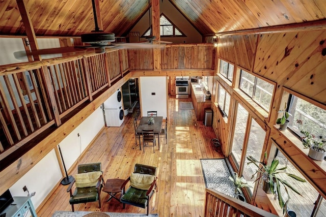 unfurnished living room with wood walls, wood ceiling, lofted ceiling, and hardwood / wood-style floors