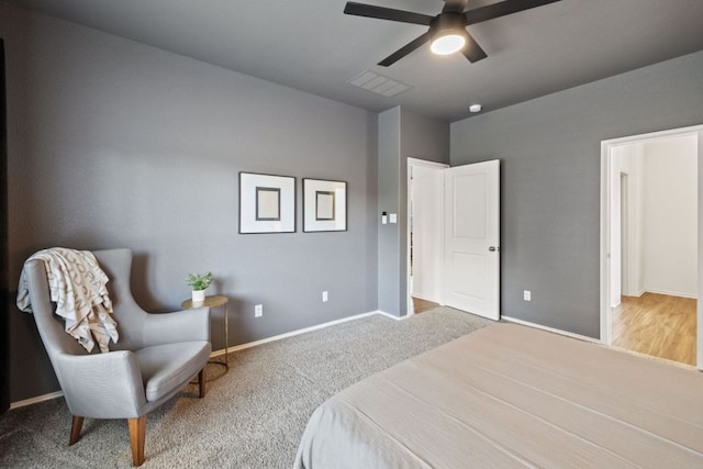 carpeted bedroom with a ceiling fan, baseboards, and visible vents