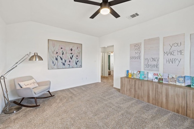 sitting room with visible vents, carpet flooring, a ceiling fan, and vaulted ceiling