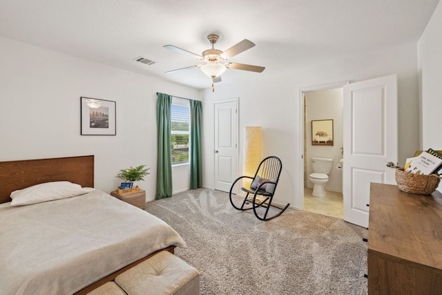 bedroom with ensuite bath, carpet flooring, a ceiling fan, and visible vents