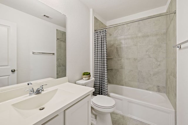 bathroom with visible vents, toilet, vanity, and shower / tub combo with curtain