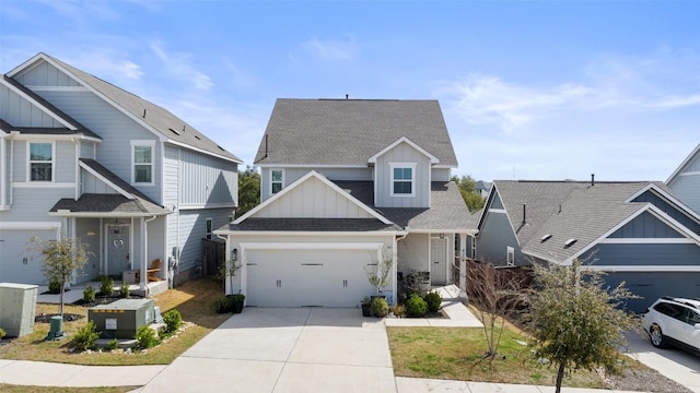 view of front of home with board and batten siding, a shingled roof, a garage, and concrete driveway