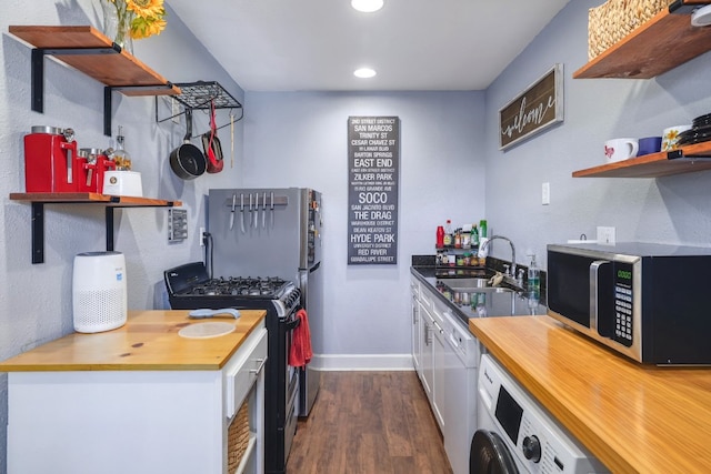 kitchen with washer / dryer, a sink, black range with gas stovetop, dishwasher, and stainless steel microwave