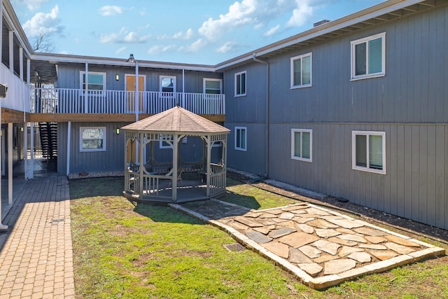 exterior space featuring a gazebo, a deck, stairs, and a patio