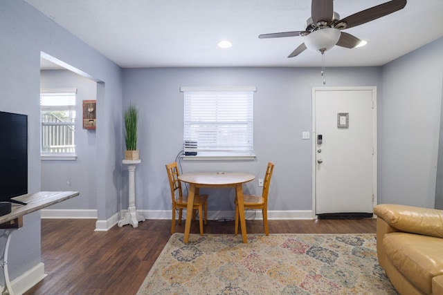 dining room with ceiling fan, baseboards, and wood finished floors