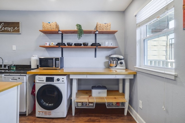 laundry room with baseboards, washer / dryer, dark wood finished floors, and laundry area