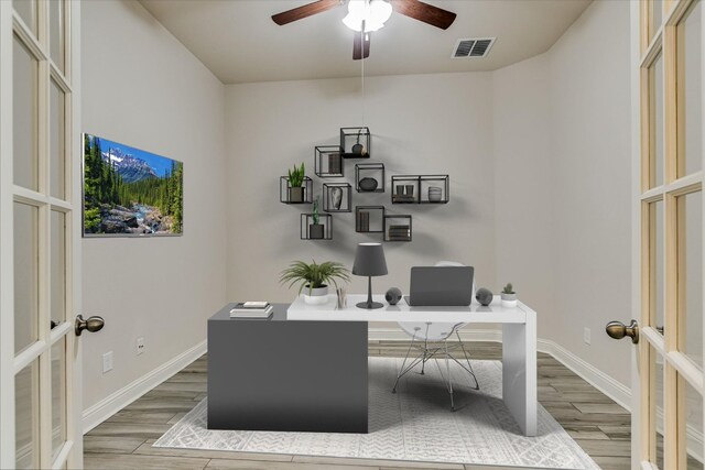 office area with visible vents, wood finish floors, baseboards, french doors, and a ceiling fan