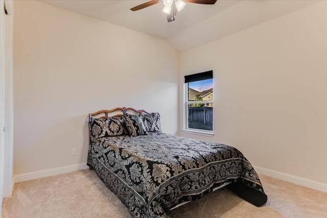 carpeted bedroom featuring a ceiling fan, baseboards, and vaulted ceiling