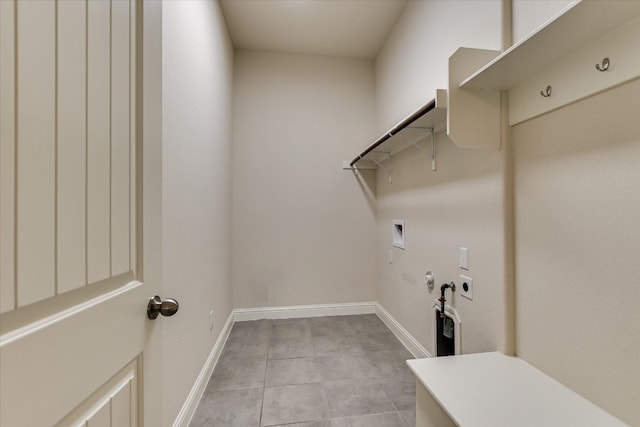 clothes washing area featuring baseboards, hookup for an electric dryer, gas dryer hookup, laundry area, and washer hookup