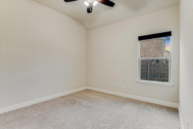 carpeted spare room with baseboards, lofted ceiling, and ceiling fan