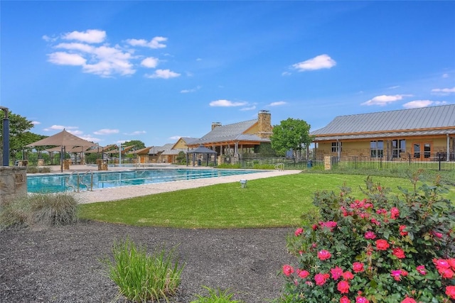 pool featuring a gazebo, a lawn, and fence