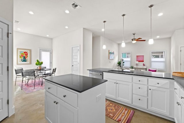 kitchen featuring dark countertops, visible vents, recessed lighting, and concrete flooring