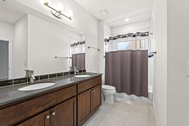 full bath featuring tile patterned flooring, double vanity, toilet, and a sink