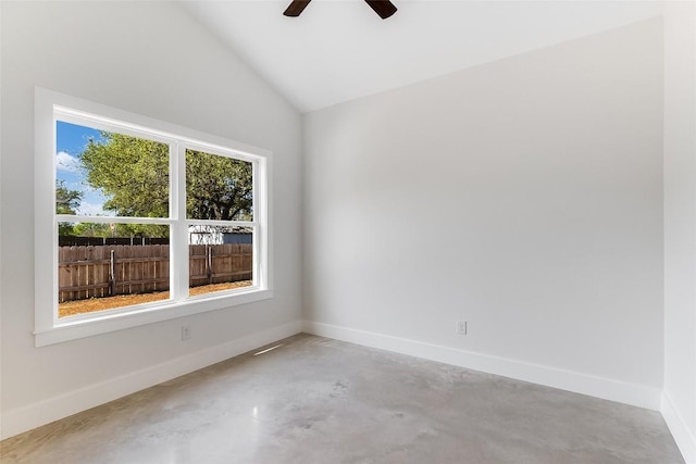 empty room featuring baseboards, concrete floors, ceiling fan, and lofted ceiling