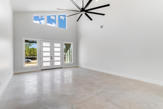 unfurnished living room with visible vents, a healthy amount of sunlight, french doors, and finished concrete floors