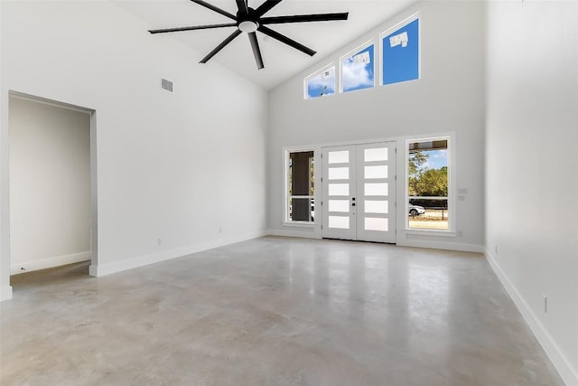 unfurnished room featuring concrete flooring, high vaulted ceiling, french doors, a ceiling fan, and baseboards