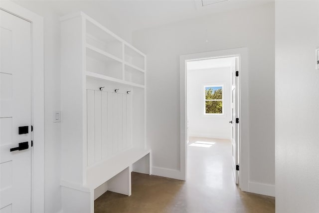 mudroom with baseboards and concrete floors