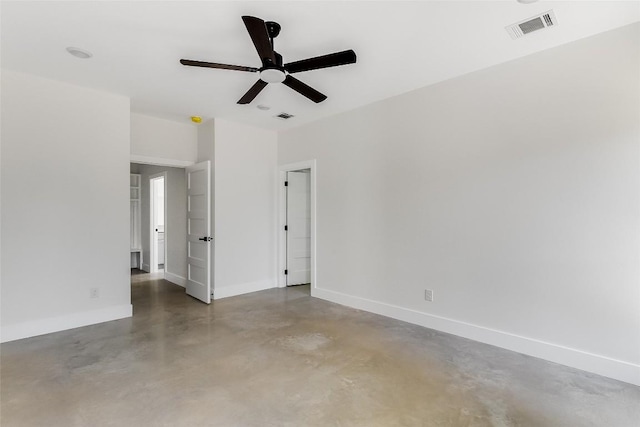 interior space with baseboards, visible vents, ceiling fan, and finished concrete flooring