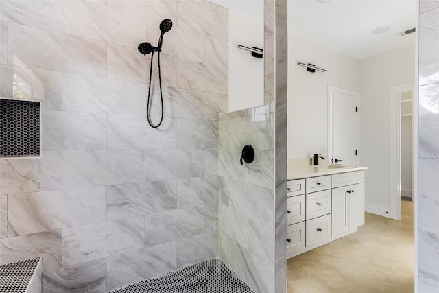 full bath with visible vents, tiled shower, and vanity