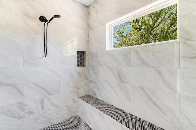 full bath with a tile shower