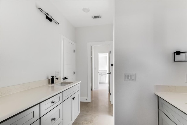 bathroom featuring visible vents, finished concrete floors, and vanity