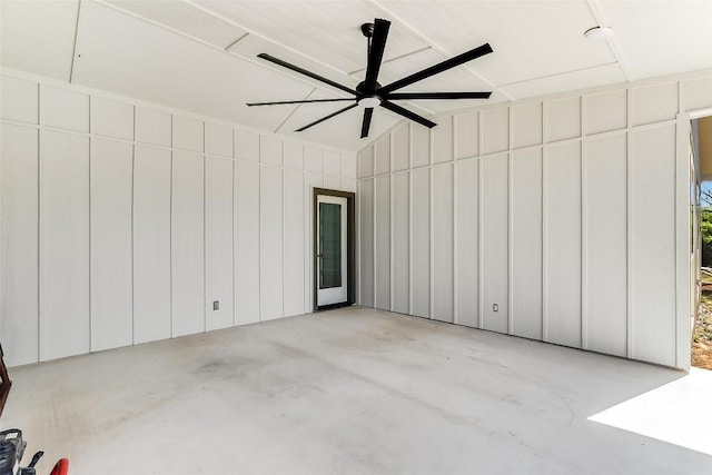 exterior space with a ceiling fan, unfinished concrete flooring, and lofted ceiling