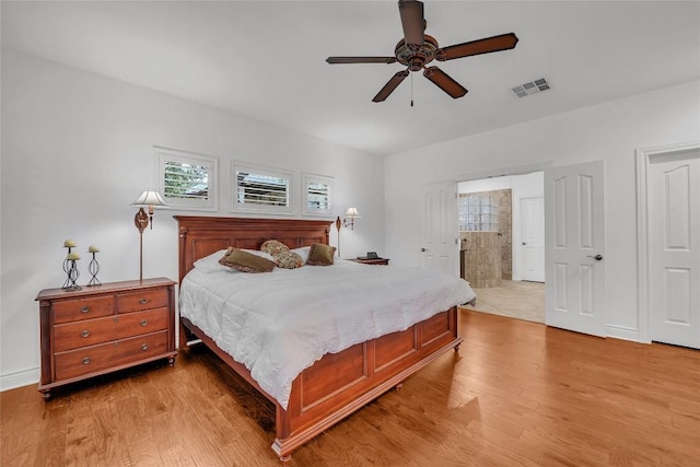 bedroom with light wood-style flooring, baseboards, visible vents, and ceiling fan