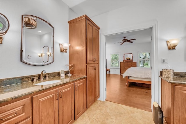 bathroom featuring tile patterned flooring, vanity, ensuite bathroom, and a ceiling fan