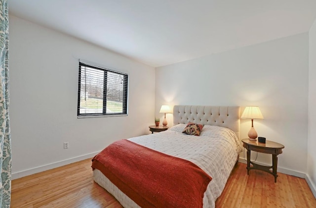 bedroom with baseboards and light wood-type flooring