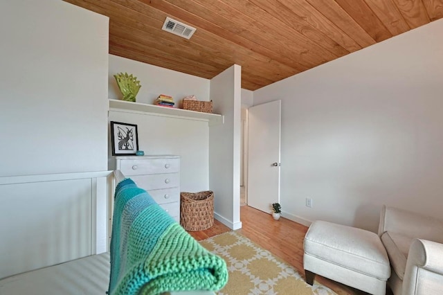 sitting room featuring visible vents, wood ceiling, baseboards, and wood finished floors