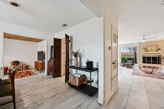 hallway with visible vents and wood tiled floor