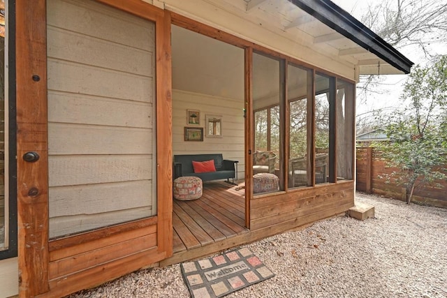 wooden terrace with fence and a sunroom