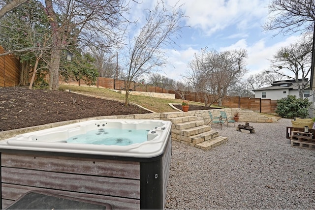 view of yard featuring a fenced backyard and a hot tub