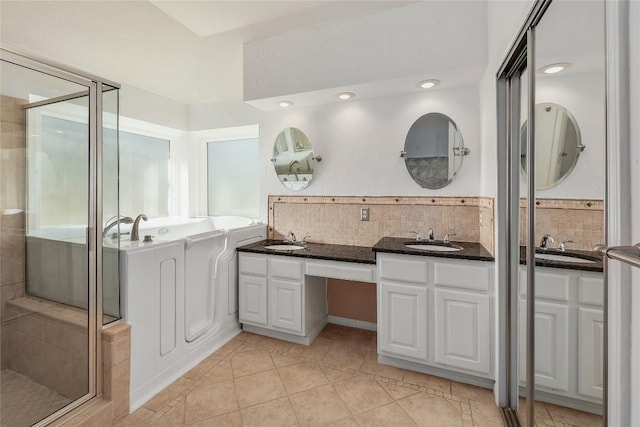 full bathroom featuring a sink, decorative backsplash, a garden tub, and a stall shower