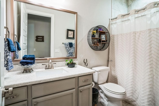 bathroom with vanity, a shower with shower curtain, and toilet